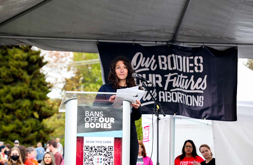 A photo of former executive director Kia Guarino giving a speech